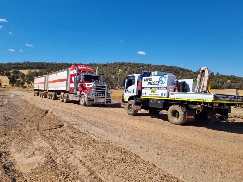 On-site maintenance being performed on earthmoving equipment at a job site