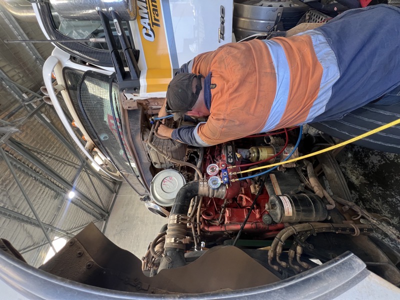 Air conditioning compressor replacement in a heavy equipment cab